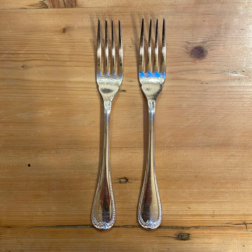 Two Christofle Malmaison pattern silver plate fish forks
